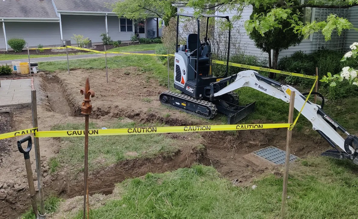 Drainage piping from side of home to Y-pipe in a trenching